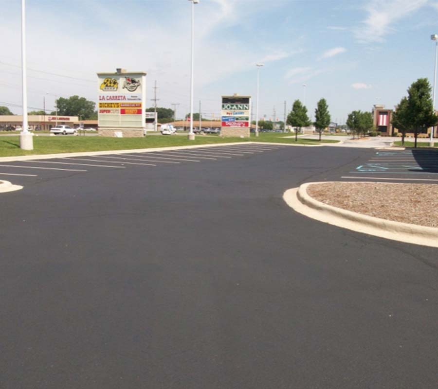 freshly sealcoated and striped parking lot at a strip mall