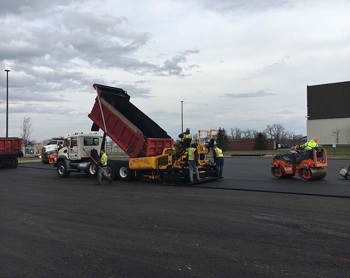 Site Services crew with equipment repaving a parking lot