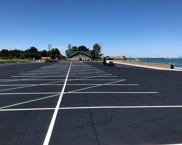 freshly sealcoated and striped parking lot by the lake