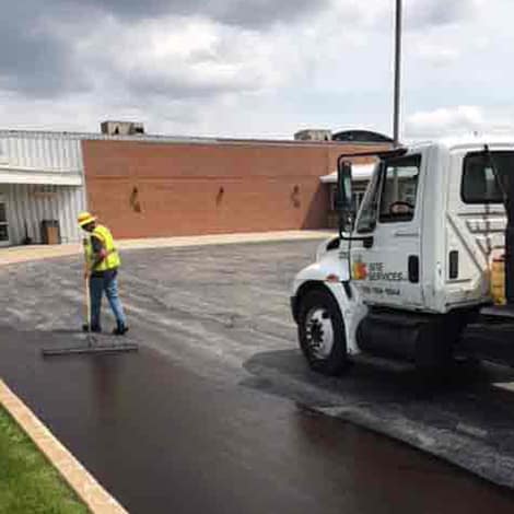 Site Services Crewman seal coating parking lot