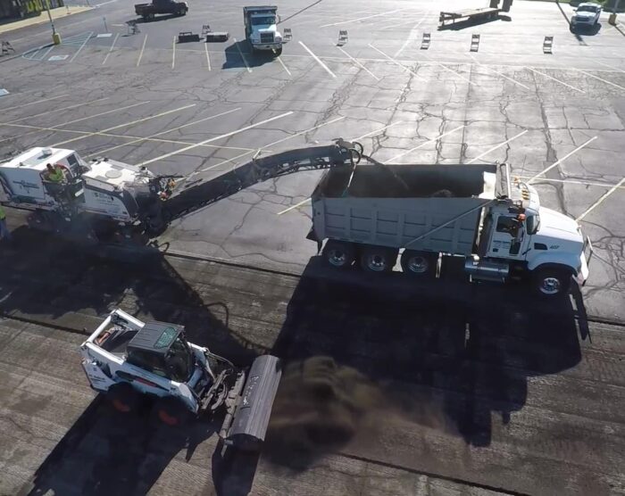Site Services crew and equipment milling, grinding, and resurfacing commercial parking lot