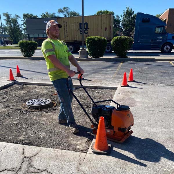 Site Services crew prepping a parking lot for asphalt repairs